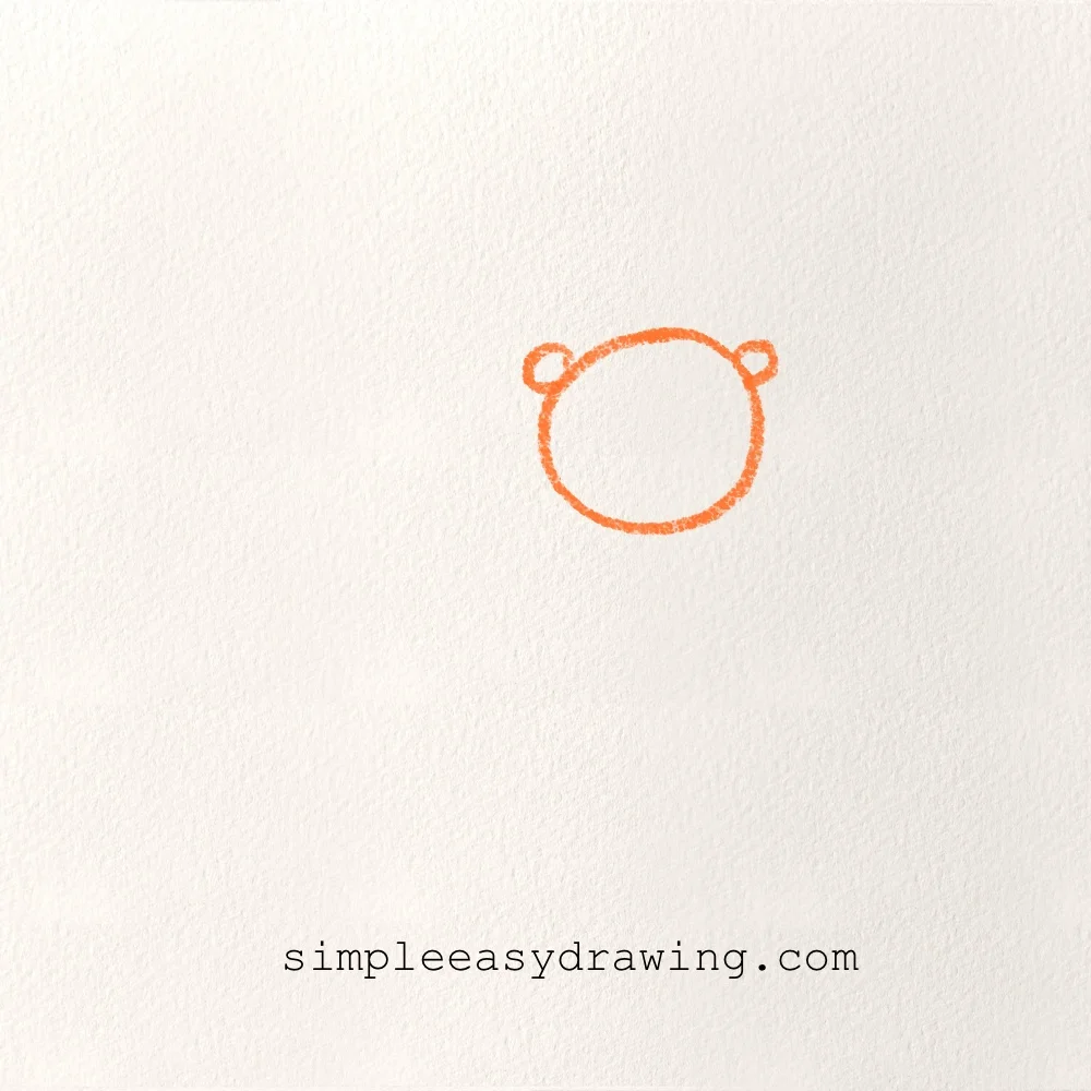 Simple circle with two small ears drawn to start the lion’s head shape