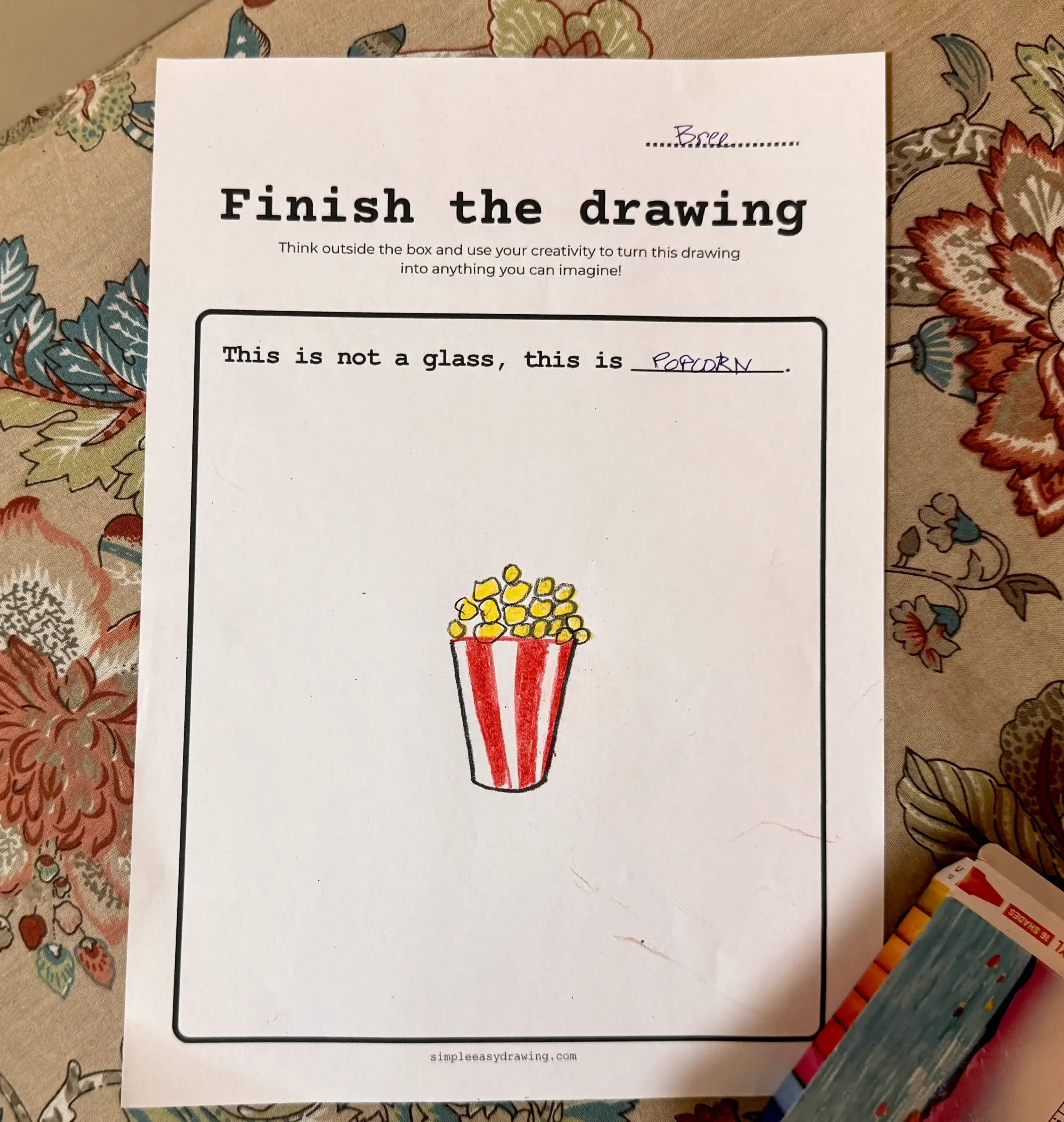 Finish the Drawing Worksheet with a glass turned into a container with popcorn.