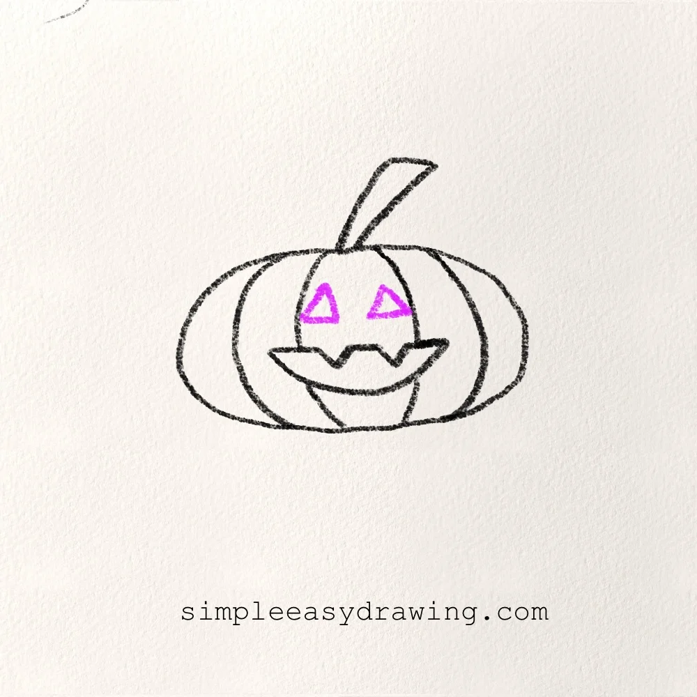 Adding triangle eyes and a spooky mouth to the Halloween pumpkin.