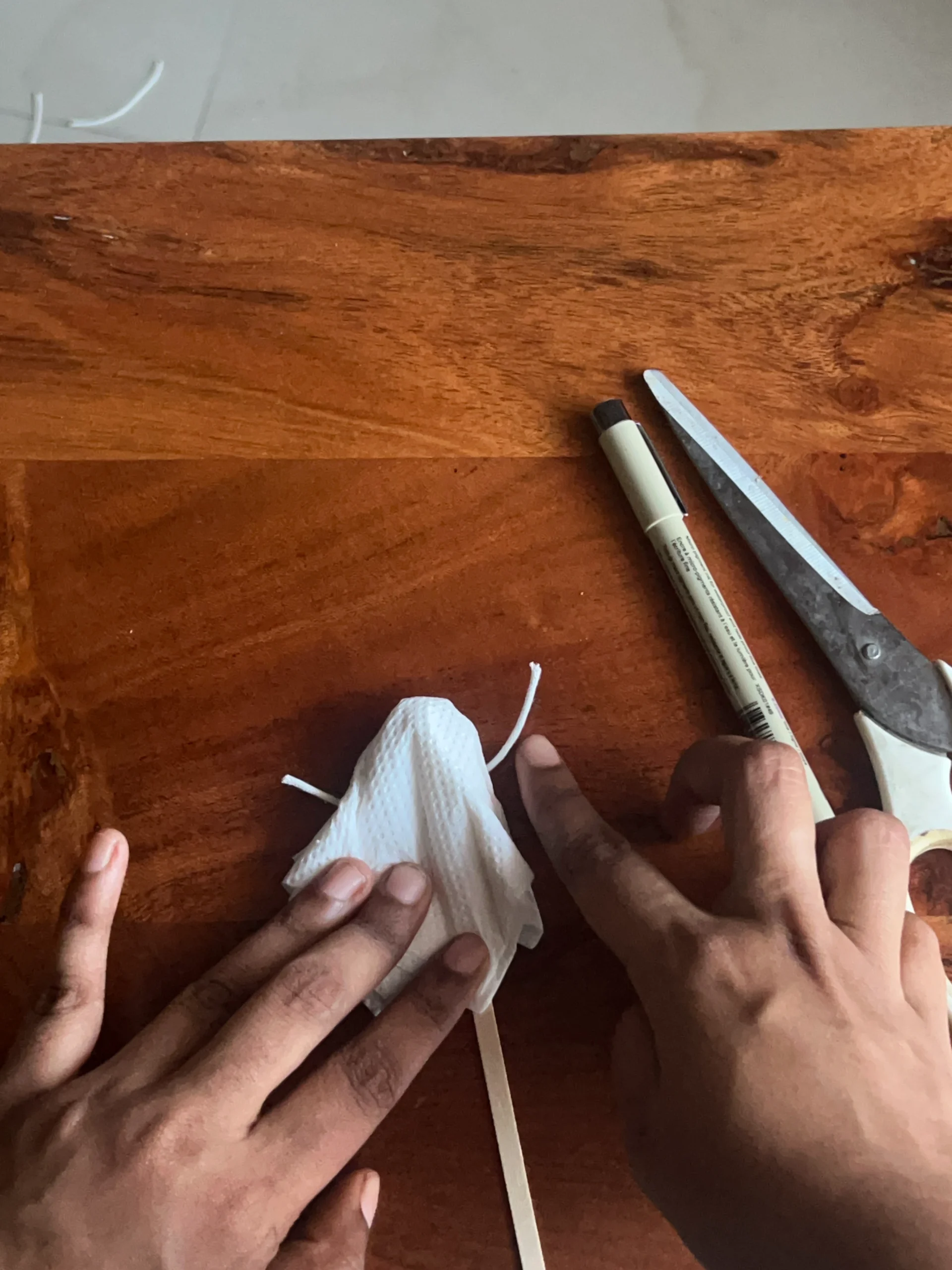 Positioning thread around the gathered tissue paper for the ghost craft.